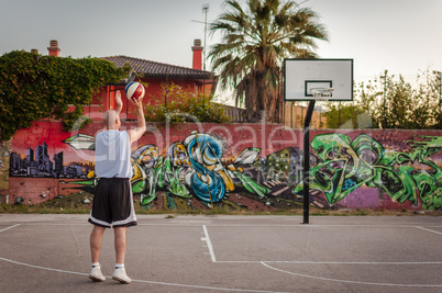 Basketball player in city playground