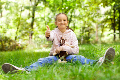 Girl sitting on green grass