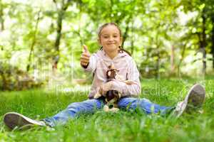 Girl sitting on green grass