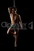 Male pole dance. Photo of muscular man posing