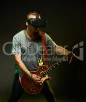 Guitarist plays in a virtual reality glasses.