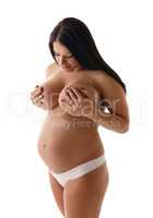 Pregnant woman posing topless. Isolated on white