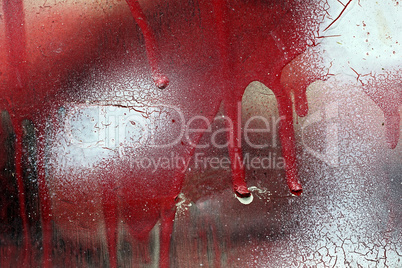 Cracked and dripping red and white paint on grunge metal