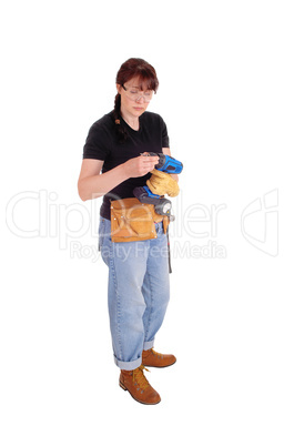 Woman preparing drill for work.