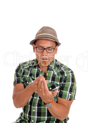 Hispanic man lightning his cigar.
