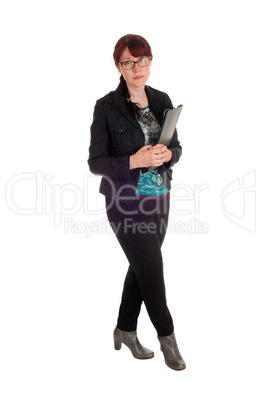 Businesswoman standing with clipboard.