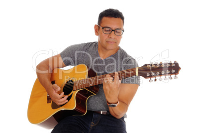 Middle age man playing his guitar.