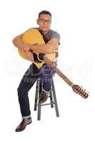 Hispanic man holding his guitar.