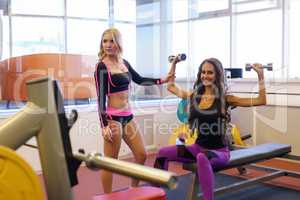 Image of girlfriends exercising in fitness room