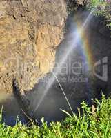 The water jet in the form of leakage in the damaged metal pipe at the production site