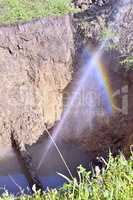 The water jet in the form of leakage in the damaged metal pipe at the production site