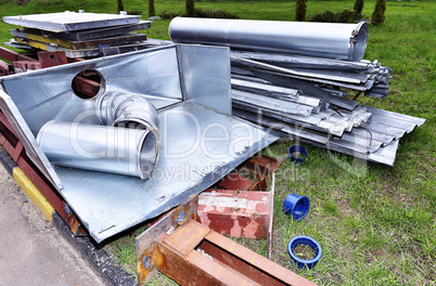 Metal parts are dismantled structures stored in the soil on the