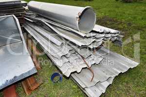 Metal parts are dismantled structures stored in the soil on the