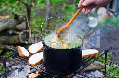 The cooking of soup on the fire