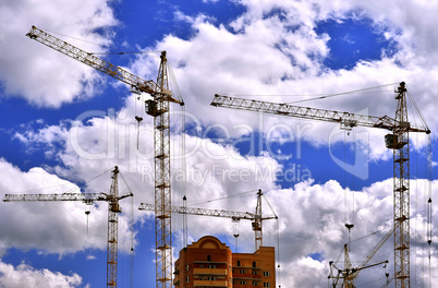 Construction site with cranes on sky background