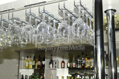 A number of washed glasses hung to dry in the bar