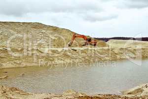 Working digger in a quarry produces sand