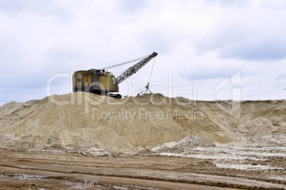Working digger in a quarry produces sand Working digger in a quarry produces sand