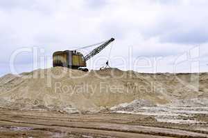 Working digger in a quarry produces sand Working digger in a quarry produces sand