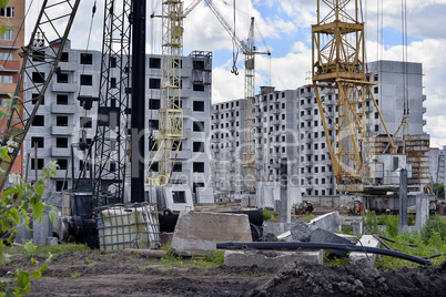 Construction site with cranes on sky background