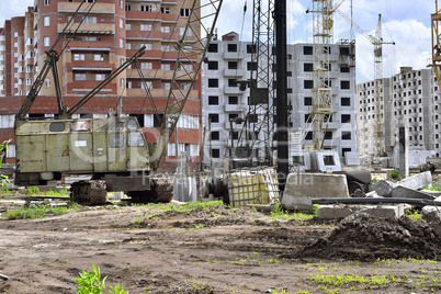 Construction site with cranes on sky background