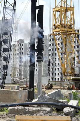 Mechanism scores piles at construction site