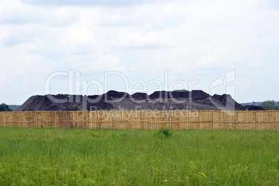 Keeping the soil in the open ground in the warehouse site with a fence