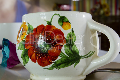 Clay cup with floral pattern