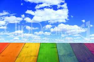 multicolored stand from wooden boards and blue sky