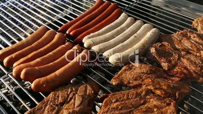 Rotate sausages on barbecue grill