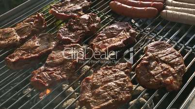 Pork meat and sausages on barbecue grill