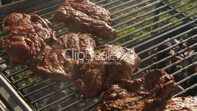 Rotate pork on a barbecue grill