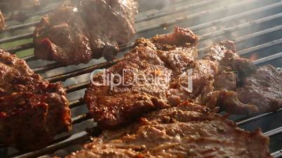 Rotate meat on a barbecue grill