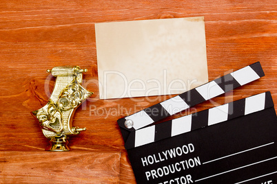 Theatrical masks and movie clapper