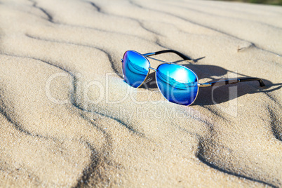 Sunglasses on the sand in the desert.