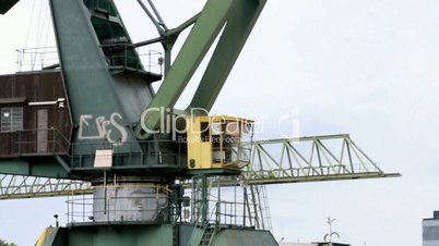 Defocus on crane on waste land port to lift heavy loads.