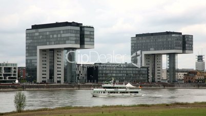Crane Houses. Time lapse. Tourist boat on the Rhine in front of Cologne's Kranhäuser.
