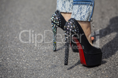 Woman feet with high heels shoes with red sole