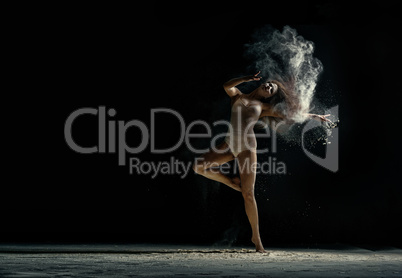 Amazing photo of graceful woman dancing with dust