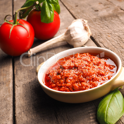 Red pesto on a wooden kitchen table