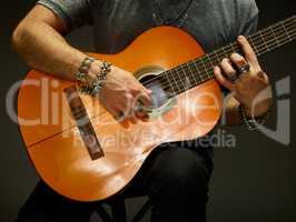 The guy playing an acoustic guitar.