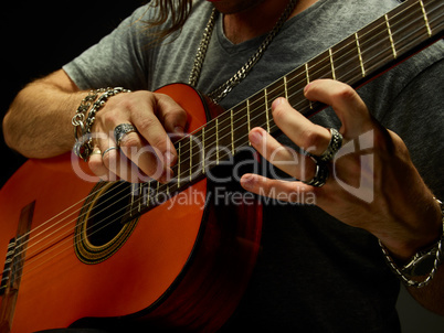 The guy playing an acoustic guitar.