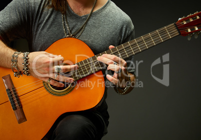 The guy playing an acoustic guitar.