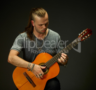 The guy playing an acoustic guitar.