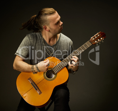 The guy playing an acoustic guitar.