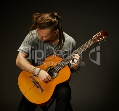 The guy playing an acoustic guitar.