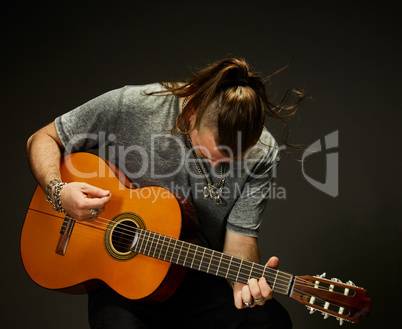 The guy playing an acoustic guitar.