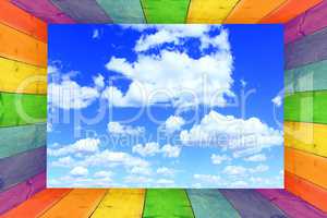 multicilored frame on the cloudy blue sky background
