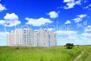 multistory modern blocks of flat in field with grass