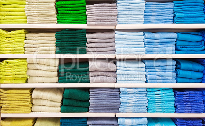 Big pile of colorful towels at shelf